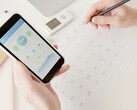 Une main tenant un smartphone sur lequel est ouverte une application de santé