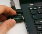 Une personne insère une clé USB de sécurité dans un ordinateur portable