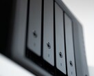Gros plan sur un boîtier NAS noir comportant plusieurs baies de disques