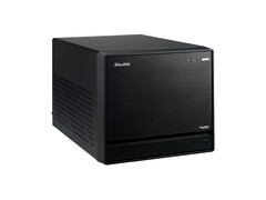 L'image montre une vue de face du Shuttle XPC Mini PC, qui ressemble à un cube noir au design minimal. 
