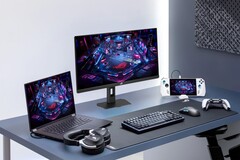Moniteur de jeu Asus XG27UCMG aux côtés de divers appareils électroniques Asus