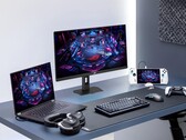 Moniteur de jeu Asus XG27UCMG aux côtés de divers appareils électroniques Asus