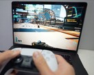 Une personne jouant à Cyberpunk 2077 sur un MacBook à l'aide d'une manette DualSense, illustrant les performances de jeu natives sur macOS. (Source de l'image : Andrew Tsai / YouTube)