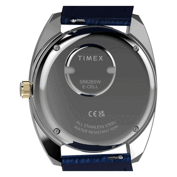 Vue arrière de la Timex Q 1976 Day and Date dorée, montrant son fond de boîtier en acier inoxydable, son compartiment à pile et son marquage d’étanchéité à 50 mètres.