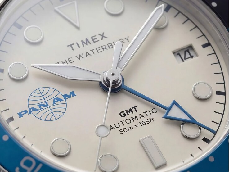 Gros plan sur la montre Timex Pan Am Waterbury Automatic GMT, montrant son cadran blanc argenté, ses index lumineux, son guichet de date et le logo Pan Am.
